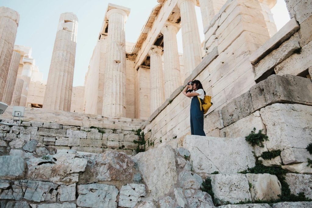 Woman Taking Pictures in Ruins of Parthenon